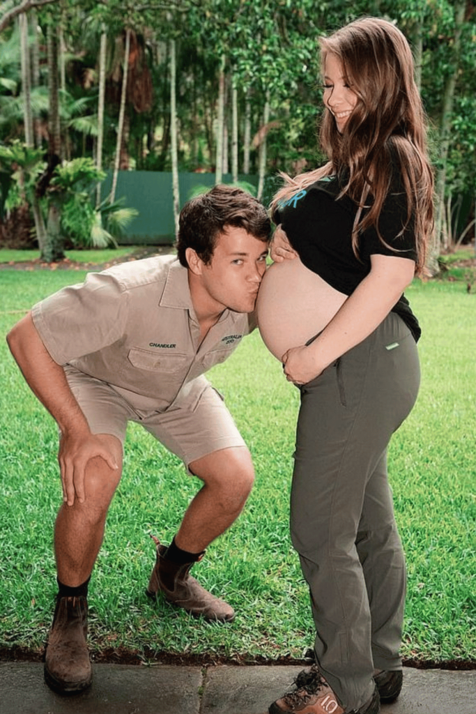 Chandler Powell kisses Bindi Irwin's stomach while she's pregnant. 