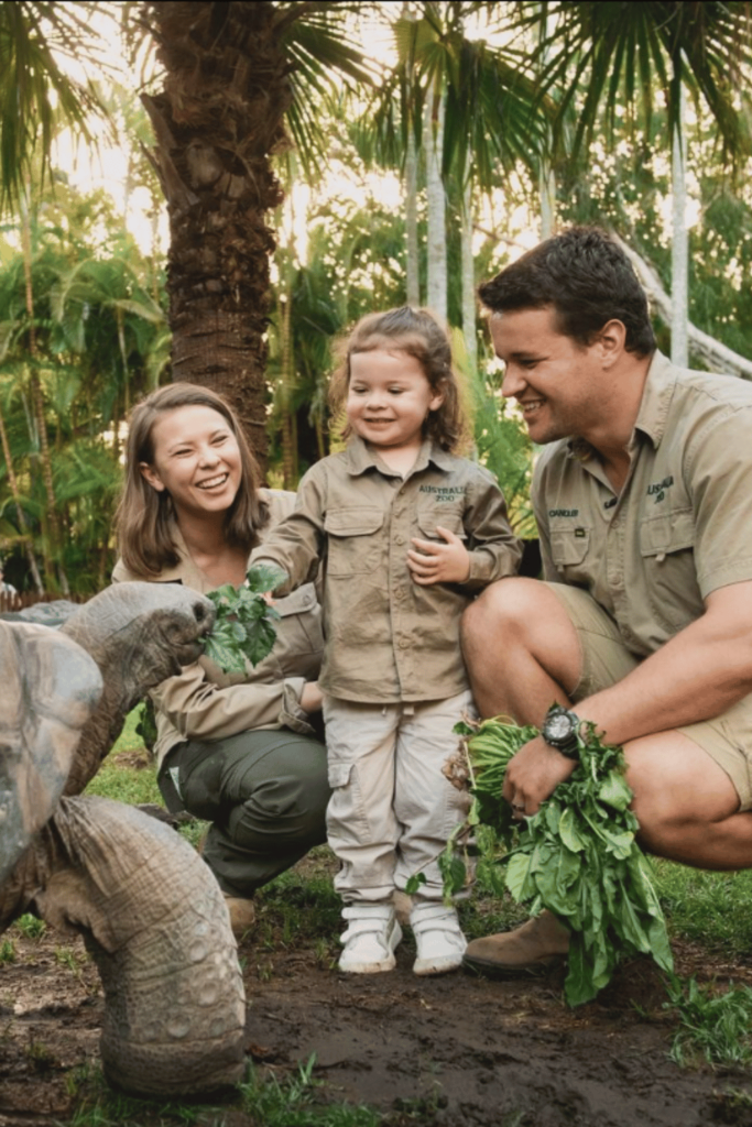 Bindi Irwin, Grace Warrior and Chandler Powell feed a turtle. 